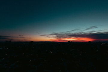 Rising sun with city silhouette skyline. Cinematic sky in the Brazilian city.