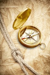 Fototapeta na wymiar Retro style antique golden compass. Sailing accessories. Wanderlust, travel and navigation theme
