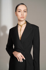 Beautiful young lady in a black pantsuit - 489913863