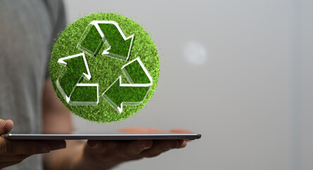 hand holding green recycle symbol