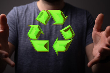 hand holding green recycle symbol