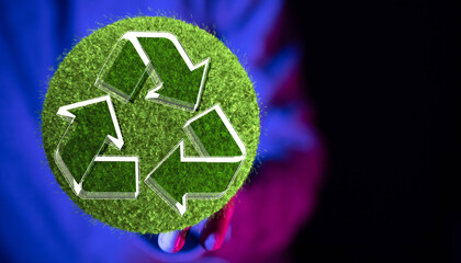 hand holding green recycle symbol