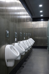 Public men's toilets lined up on the wall