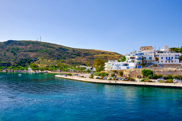 Fototapeta na wymiar Beautiful summer day, sunshine in typical town of Greek island. Whitewashed houses on hills. Mediterranean vacations. Milos, Cyclades, Greece.