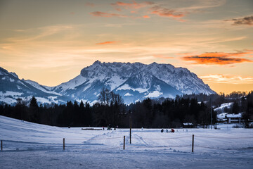 View to the Austrian mountain called Wilder Kaiser from german village Reit im Winkl in beautiful sunset light, copy space