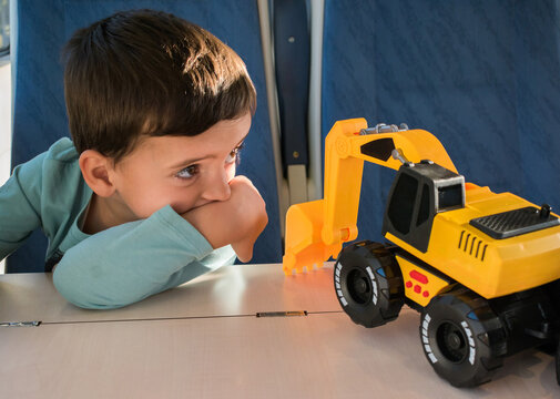 Child Playing With Toy Truck