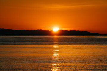 Distant view of the sunset over the Olympic Mountains