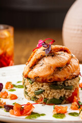 grilled fish with a side dish on a wooden background. Restaurant