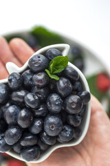 Assortment of red fruits, strawberries, blueberries and raspberries, close up
