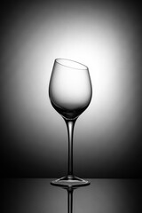 Glass goblet with a beveled top edge on a white background in vignette