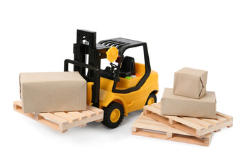 Toy forklift, wooden pallets and boxes on white background