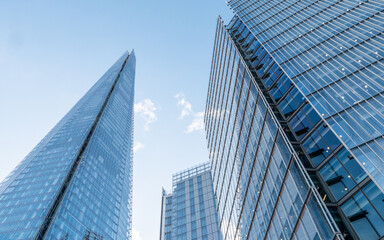 The Shard Quarter, London. A low, wide angle view of the modern glass and steel architecture and skyscrapers in London's growing business district. - Powered by Adobe