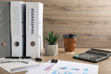 Bookkeeper's workplace with folders and documents on table