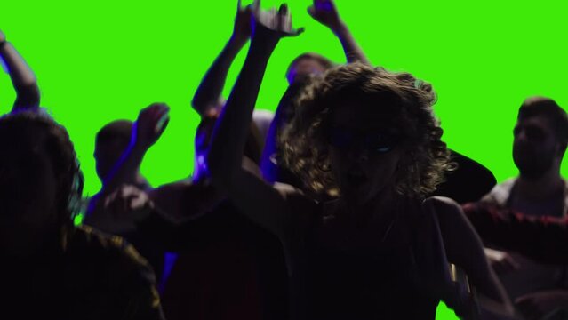 a few joyful people are dancing together at a discotheque in slow-motion greenscreen