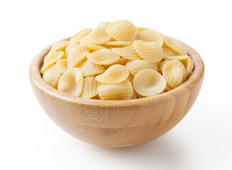 Uncooked orecchiette pasta in wooden bowl isolated on white background with clipping path