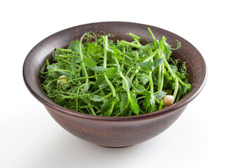 Fresh microgreens of pea in ceramic bowl isolated on white background with clipping path