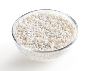 Uncooked arborio rice in glass bowl isolated on white background with clipping path