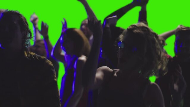a few joyful people are dancing together at a discotheque greenscreen