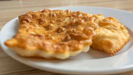 Homemade pasties with meat filling on white plate. traditional Caucasian and Russian cuisine. Take away food concepts