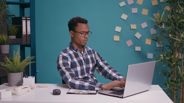 Exhausted worker doing timeout sign with hands in front of laptop screen, showing t shape symbol to take break from business work. Tired person hoping for pause after being overworked.