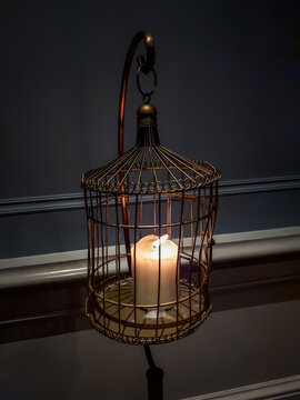 Candle Burning in a Cage in an Old House