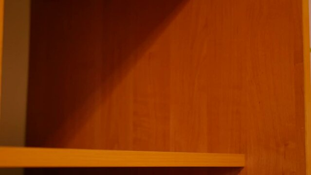 Clothes decluttering concept. Laundry 4k video. Wardrobe shelf mess. 