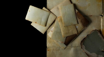 Retro photo frame on old paper isolated on black