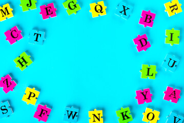 Top view of english alphabet from multi-colored puzzles Simulator for learning English. Educational process. School, lessons, pedagogy. The concept of thinking development, grammar.