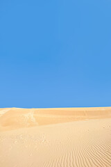 Blue sky and yellow sand desert nature background. Creative idea of Ukraine flag. Copy space background. World peace concept.