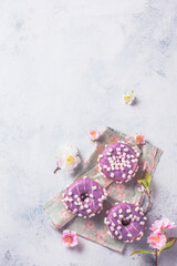 Tasty sweet donuts on a gray background