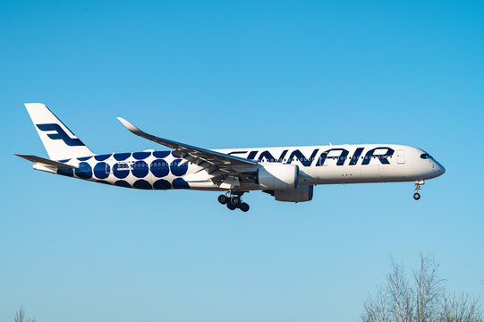 An Airbus A350 with special Marimekko livery, operated by the Finnish flag carrier Finnair, on final approach at Helsinki-Vantaa airport.