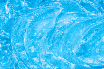 Blue cream texture. The surface of berry yogurt and a smoothie of whipped cream. Background texture of masks and scrubs for face and body. Pearlescent silver surface of blue foam.