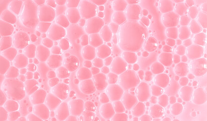 Bubble pink background texture. Berry gel to cleanse the skin of the face and body. Spa treatments, skin care. Bath foam, detergent. Slime pink.