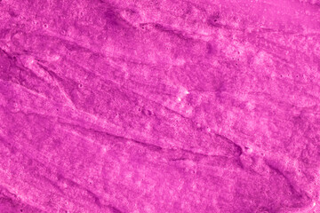 Smears of liquid purple magenta gel texture background. Smeared oil paint with pearly shine. Cream scrub to cleanse the skin of the face and body. Spa treatments, skin care.