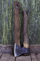 rural still life with two old axes on the wooden background