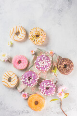Tasty sweet donuts on a gray background