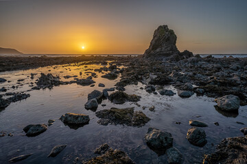 Sunset over Widemouth Bay rocks near Bude