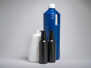 Plastic bottles and empty containers of products used in domestic life. Packaging trash in the household. Group of hollow plastic objects that are not sustainable or ready for reuse.