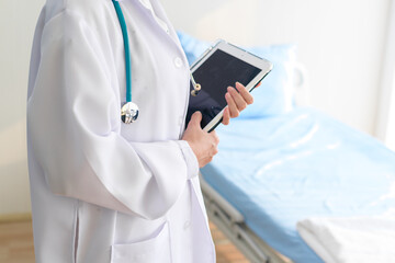 Portrait of young female doctor with stethoscope working at hospital, medical and health care concept