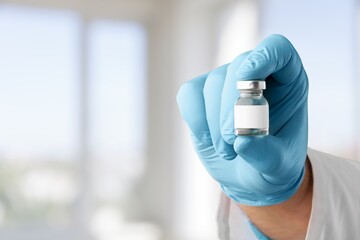 The nurse hand holding the covid vaccine booster shot