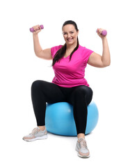 Happy overweight woman with dumbbells sitting on fitness ball against white background - obrazy, fototapety, plakaty