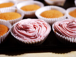 Home baked cupcake decorated with pink frosting 