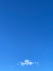 single white cloud and clear blue sky with copy space
