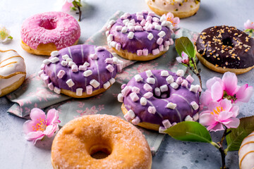 Tasty sweet donuts on a gray background