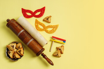 Purim Festival objects and Scroll of Esther on Yellow background.