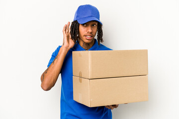Young African American delivery man isolated on white background trying to listening a gossip.