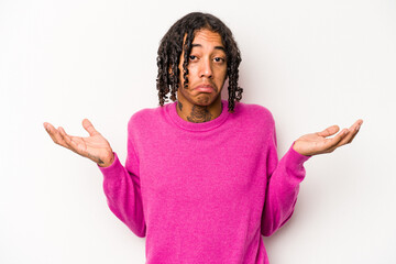 Young African American man isolated on white background doubting and shrugging shoulders in...