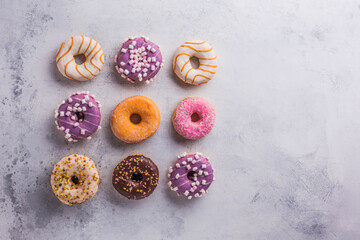 Tasty sweet donuts on a gray background