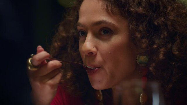 African american woman eating enjoying delicious dessert culinary in restaurant.