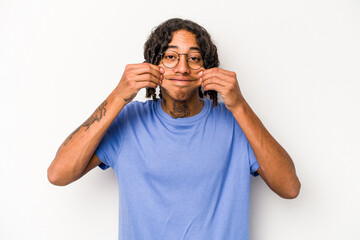 Young African American man isolated on white background doubting between two options.